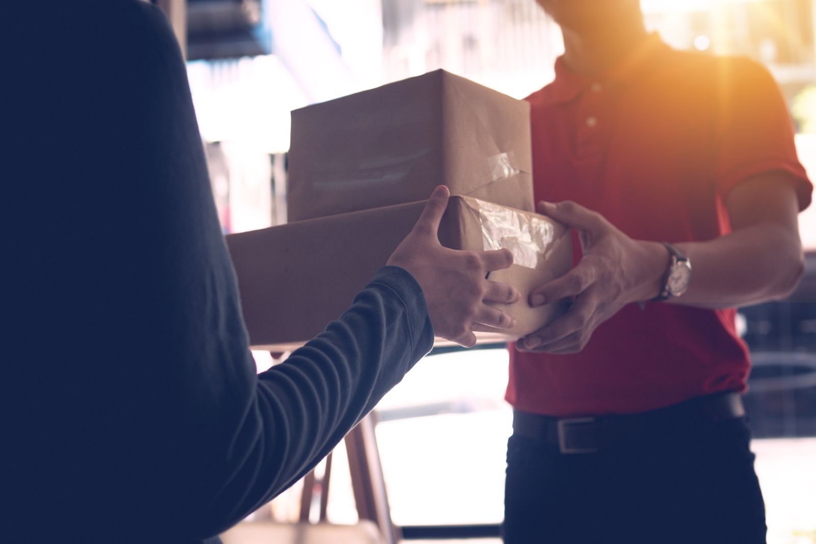 Courier handing a parcel to a customer