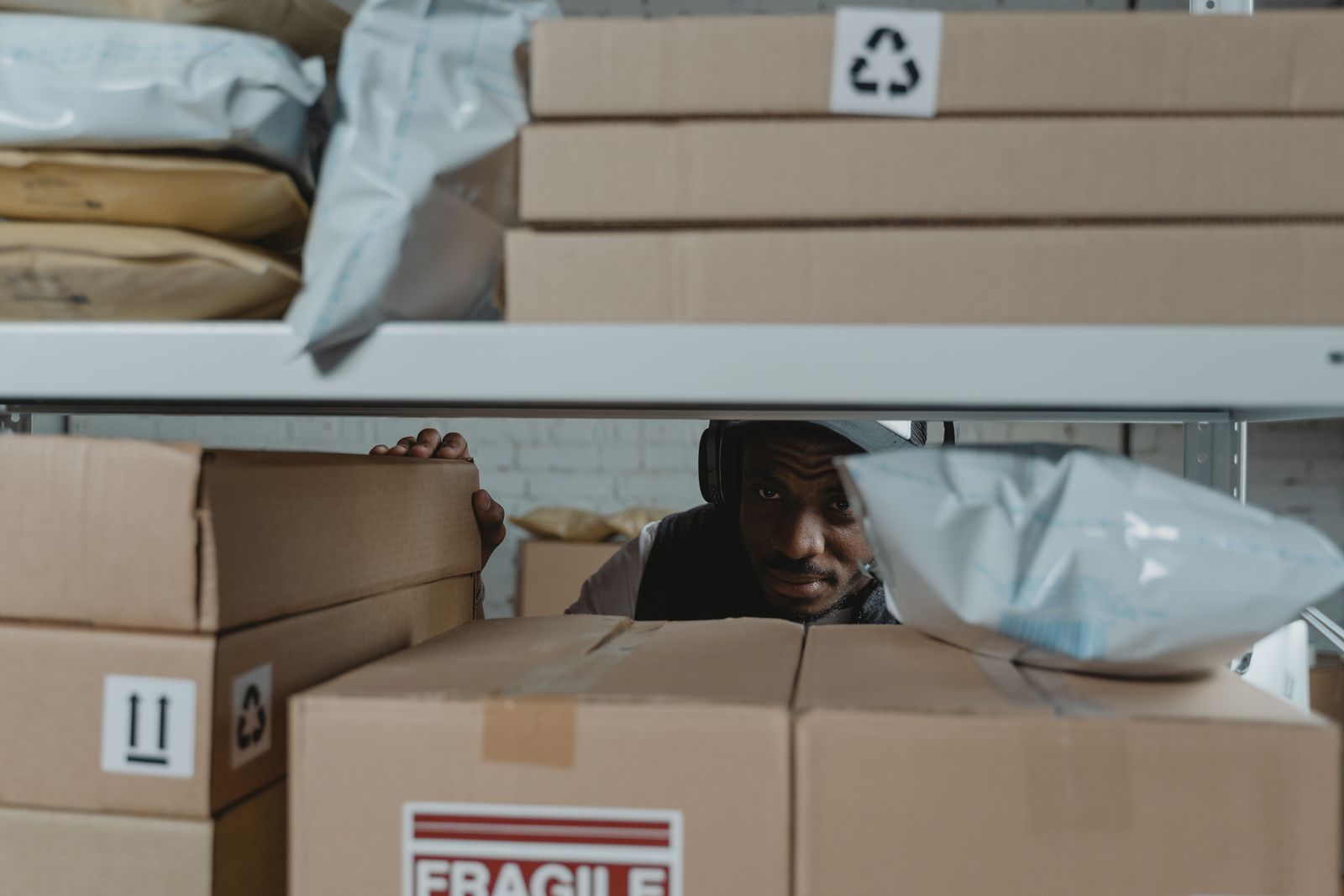 Warehouse worker handling parcels in storage